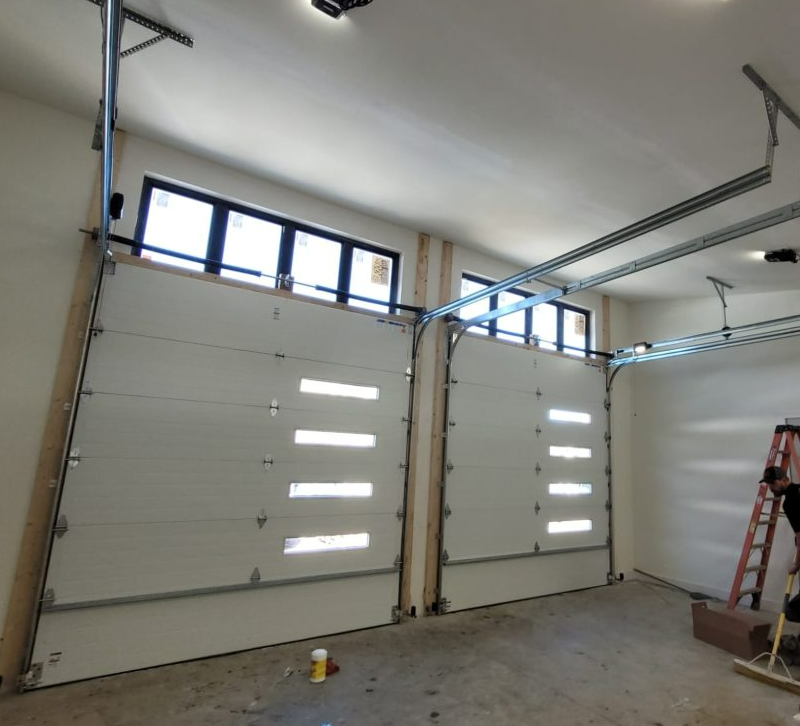 Custom garage door repair services in Jupiter, FL, showcasing a high-quality, modern garage door with professional maintenance work in progress.