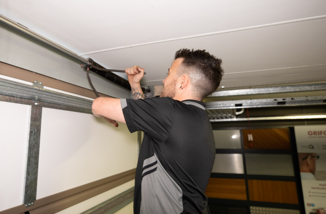 How Professional Garage Door Repair Mitigates Rail Deflection