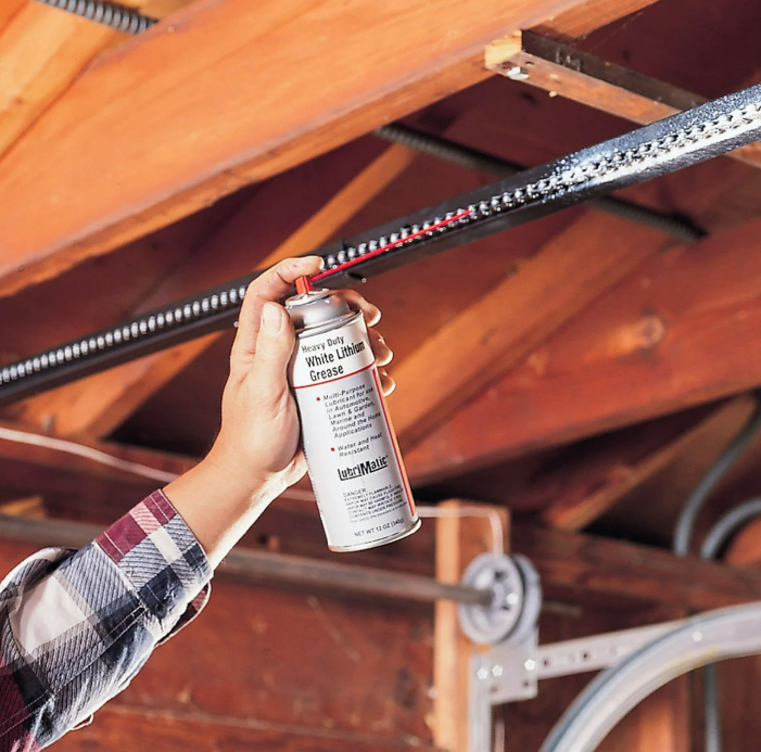 Professional technicians fixing a noisy garage door in Jupiter, FL - Expert garage door repair services for quiet and smooth operation