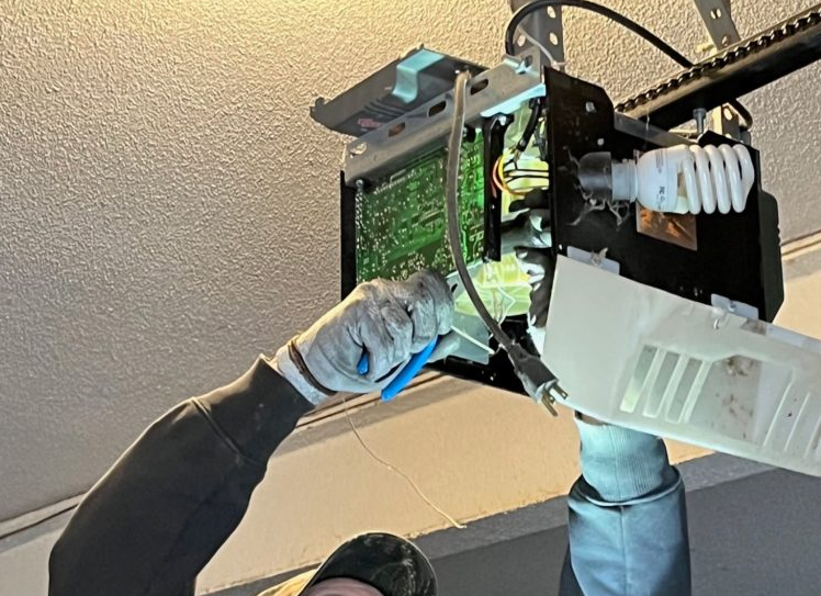 Technician performing garage door opener repair in Jupiter, FL for enhanced safety and efficiency.