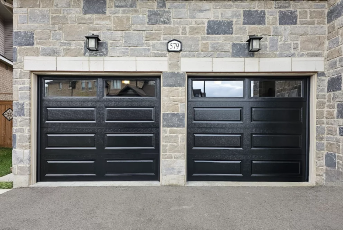 Jupiter FL Garage Door Repair Services team members posing in front of a garage door, showcasing their expertise and dedication to quality service in garage door repair and maintenance.