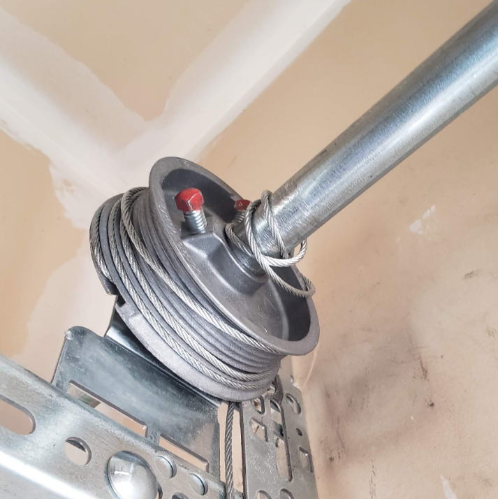 Technician performing garage door cable repair in Jupiter, FL